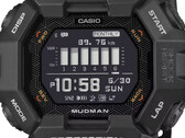 Reloj Casio G-Shock Mudman GDG-B100 con pantalla digital roja y blanca ante un paisaje montañoso escarpado.